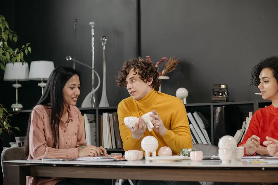 Two people browsing online clothing store on a laptop from above.